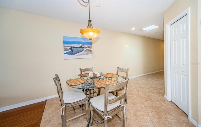 dining space with light tile patterned flooring and baseboards