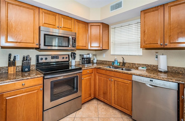 kitchen with visible vents, a sink, brown cabinetry, and appliances with stainless steel finishes