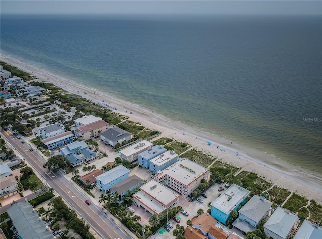 bird's eye view featuring a water view and a beach view