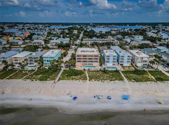birds eye view of property featuring a beach view and a water view