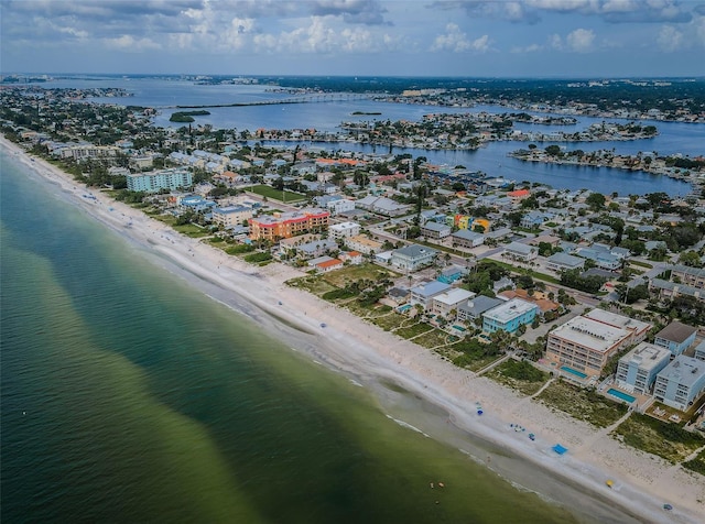 bird's eye view with a water view and a beach view
