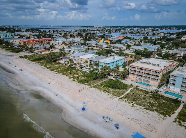 birds eye view of property with a view of the beach and a water view