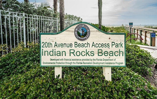 community sign featuring fence