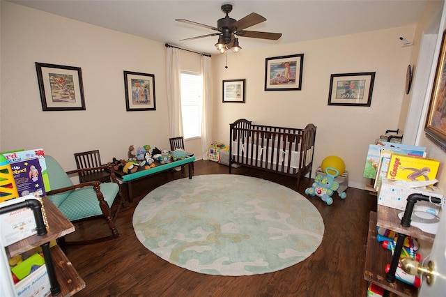 bedroom featuring a ceiling fan, baseboards, and wood finished floors
