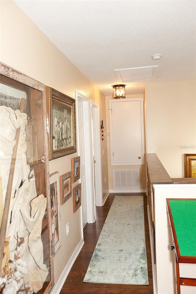 interior space featuring visible vents, dark wood finished floors, and baseboards