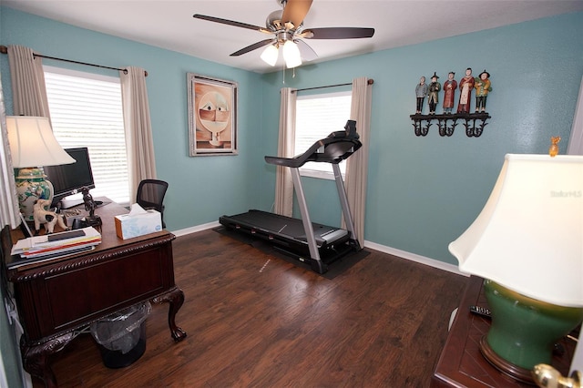 office area featuring baseboards, ceiling fan, and wood finished floors