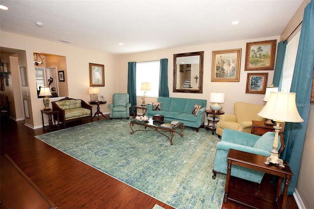 living area with recessed lighting, baseboards, and wood finished floors