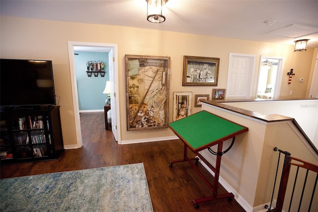 rec room with baseboards and wood finished floors