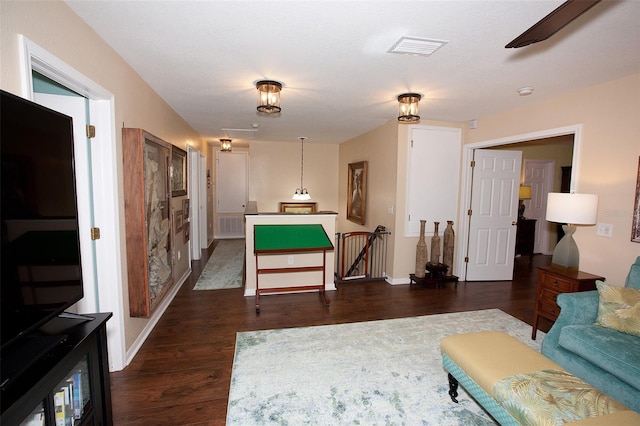 interior space featuring dark wood-style flooring and visible vents