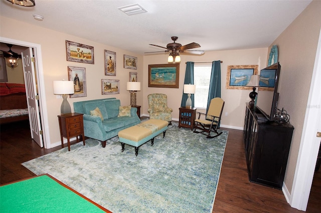 living area with baseboards, a ceiling fan, dark wood-style floors, and visible vents