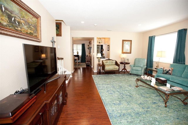 living area featuring recessed lighting and dark wood-style flooring