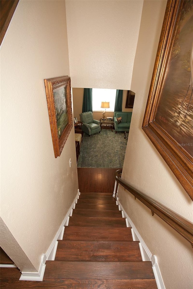 stairs featuring baseboards and wood finished floors