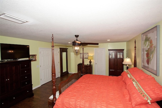 bedroom with a ceiling fan, wood finished floors, and visible vents