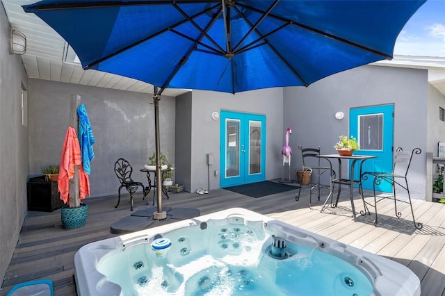 view of pool featuring french doors and a deck