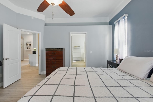 4101 Brooke Dr, Valrico, FL 33594 - bedroom with light wood finished floors, ensuite bathroom, baseboards, and ceiling fan
