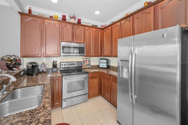 6902 47th Ln N, Pinellas Park, FL 33781 - kitchen featuring a sink, appliances with stainless steel finishes, ornamental molding, and light tile patterned floors
