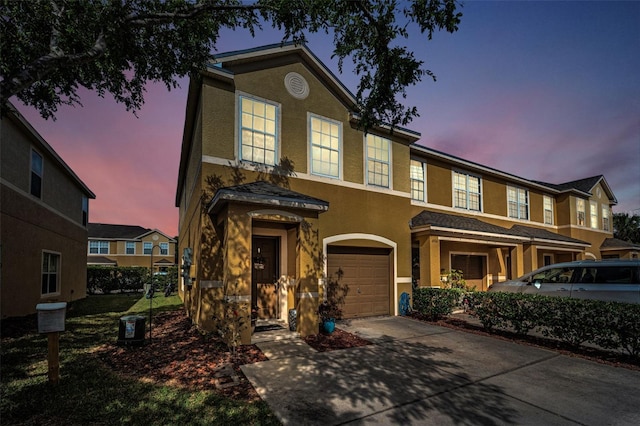 6902 47th Ln N, Pinellas Park, FL 33781 - townhome / multi-family property featuring an attached garage, driveway, and stucco siding