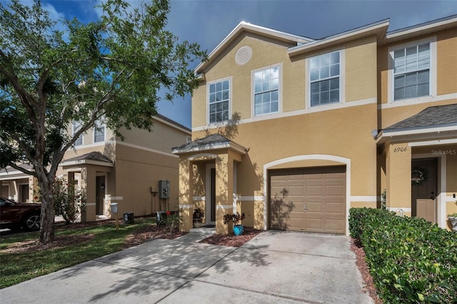 6902 47th Ln N, Pinellas Park, FL 33781 - view of front facade with an attached garage, stucco siding, and concrete driveway
