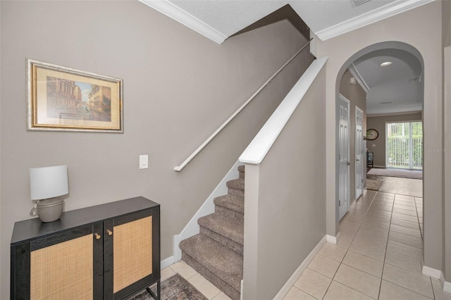 6902 47th Ln N, Pinellas Park, FL 33781 - stairway featuring baseboards, ornamental molding, arched walkways, and tile patterned floors