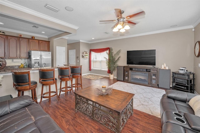 6902 47th Ln N, Pinellas Park, FL 33781 - living area featuring visible vents, a ceiling fan, dark wood finished floors, and crown molding
