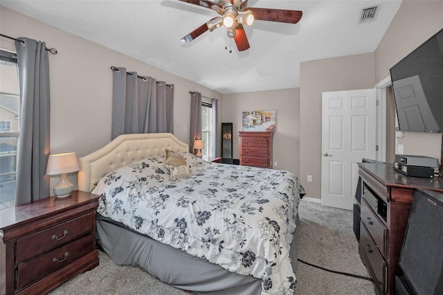 6902 47th Ln N, Pinellas Park, FL 33781 - bedroom with visible vents, a ceiling fan, baseboards, and light colored carpet