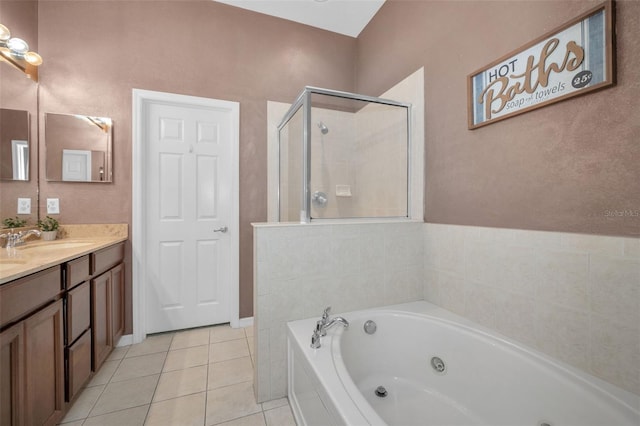 6902 47th Ln N, Pinellas Park, FL 33781 - full bathroom with double vanity, tile patterned flooring, a shower stall, a tub with jets, and a sink