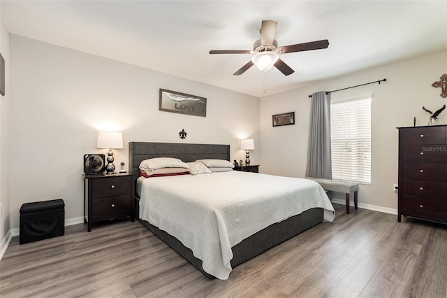 bedroom with baseboards, light wood-style floors, and ceiling fan