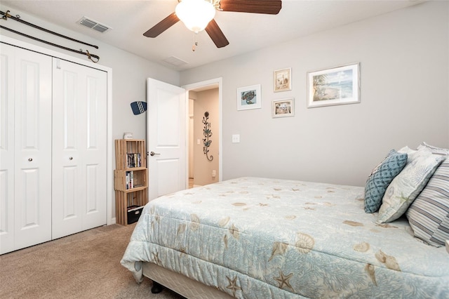 carpeted bedroom featuring a closet, visible vents, and a ceiling fan