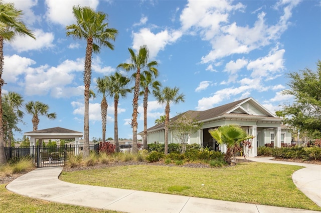 view of home's community featuring fence and a lawn