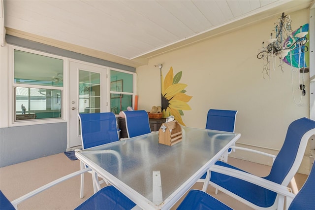 dining space with french doors, an office area, and wood ceiling