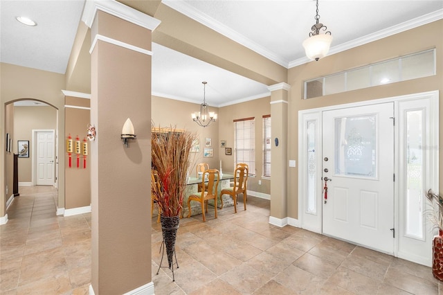 11845 Newberry Grove Loop, Riverview, FL 33579 - foyer with baseboards, crown molding, a chandelier, arched walkways, and light stone finish flooring