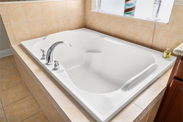 11845 Newberry Grove Loop, Riverview, FL 33579 - bathroom with a relaxing tiled tub and tile patterned floors