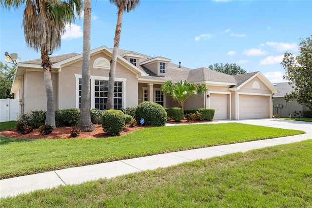 11845 Newberry Grove Loop, Riverview, FL 33579 - view of front of home featuring a garage, stucco siding, and driveway