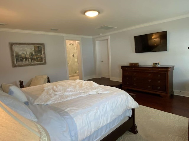 bedroom featuring ensuite bathroom, visible vents, wood finished floors, baseboards, and ornamental molding