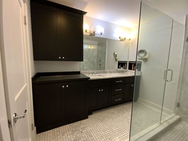 full bathroom with double vanity, a shower stall, and a sink