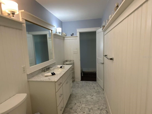 half bath featuring toilet and vanity