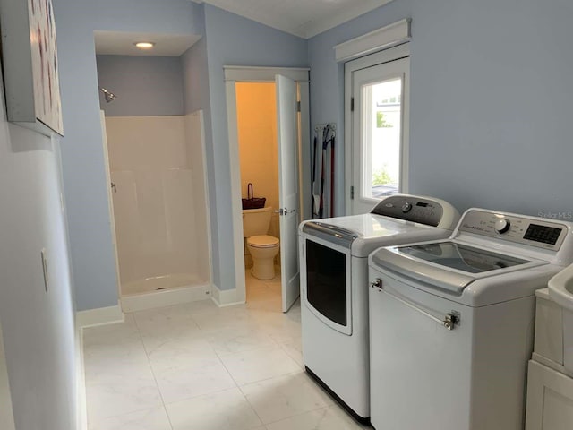 laundry area with separate washer and dryer, marble finish floor, cabinet space, and baseboards