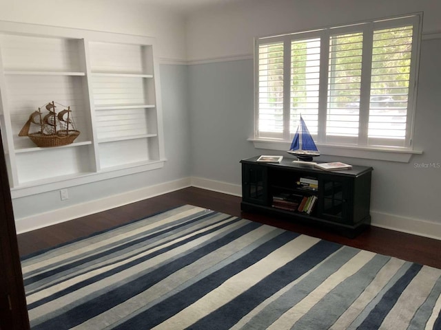 209 Rosery Rd, Belleair, FL 33756 - unfurnished room featuring baseboards, wood finished floors, and built in shelves