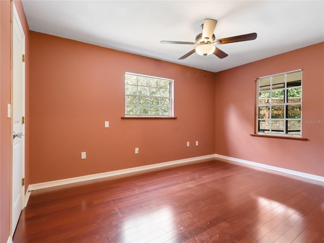 unfurnished room featuring baseboards, a ceiling fan, and wood finished floors