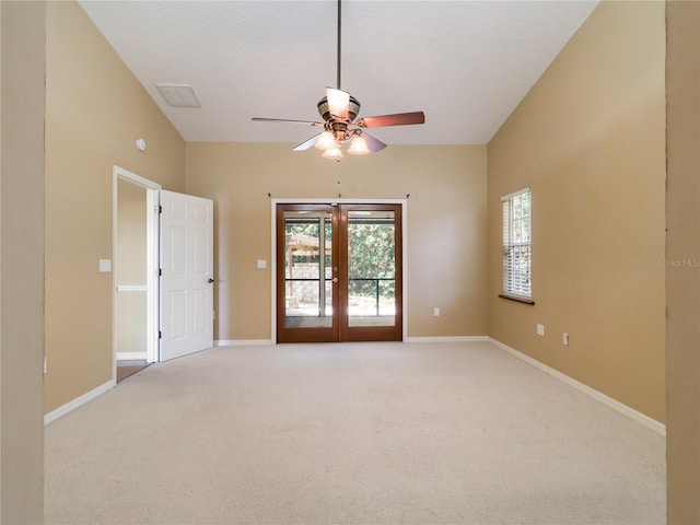 spare room featuring ceiling fan, light carpet, baseboards, and french doors