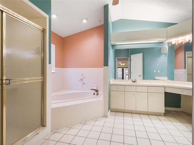 bathroom featuring a shower stall, tile patterned floors, a garden tub, and vanity