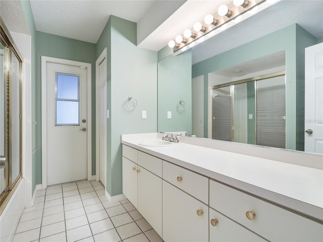 bathroom featuring vanity, baseboards, and tile patterned flooring