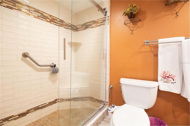bathroom featuring a shower stall and toilet