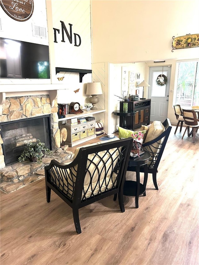 dining space featuring wood finished floors and a fireplace