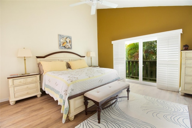 bedroom featuring light wood-style flooring, a high ceiling, access to exterior, and ceiling fan