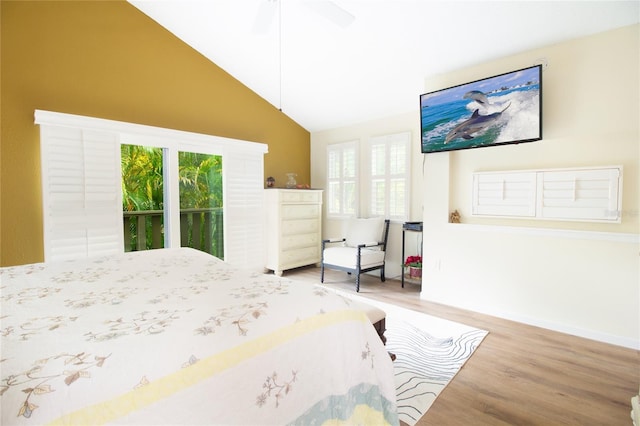 bedroom with wood finished floors, multiple windows, lofted ceiling, baseboards, and ceiling fan
