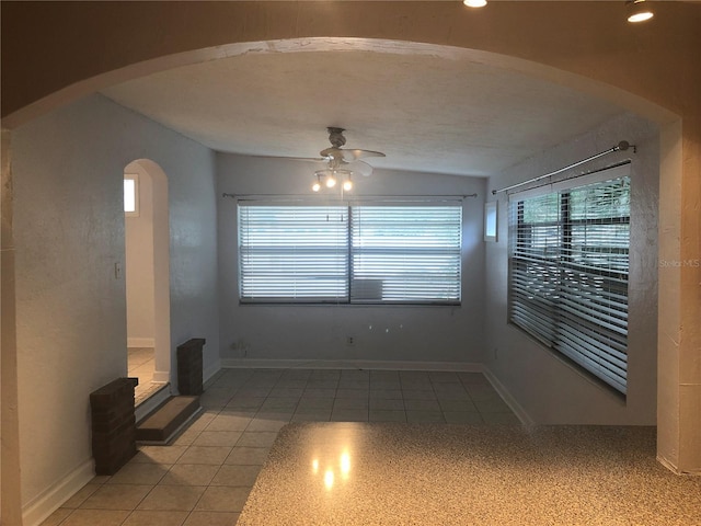 122 19th Ave N, Saint Petersburg, FL 33704 - unfurnished room featuring baseboards, a ceiling fan, arched walkways, and light tile patterned floors