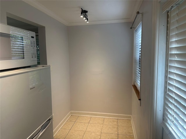 122 19th Ave N, Saint Petersburg, FL 33704 - unfurnished dining area with track lighting, light tile patterned flooring, baseboards, and ornamental molding