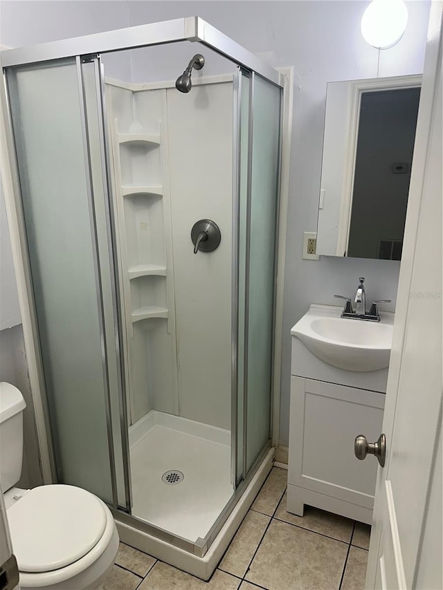 122 19th Ave N, Saint Petersburg, FL 33704 - bathroom featuring tile patterned flooring, a stall shower, toilet, and vanity