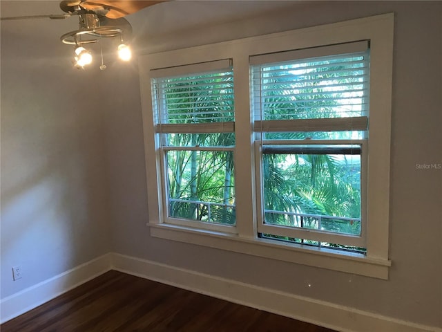 122 19th Ave N, Saint Petersburg, FL 33704 - spare room with dark wood-style flooring, baseboards, and ceiling fan